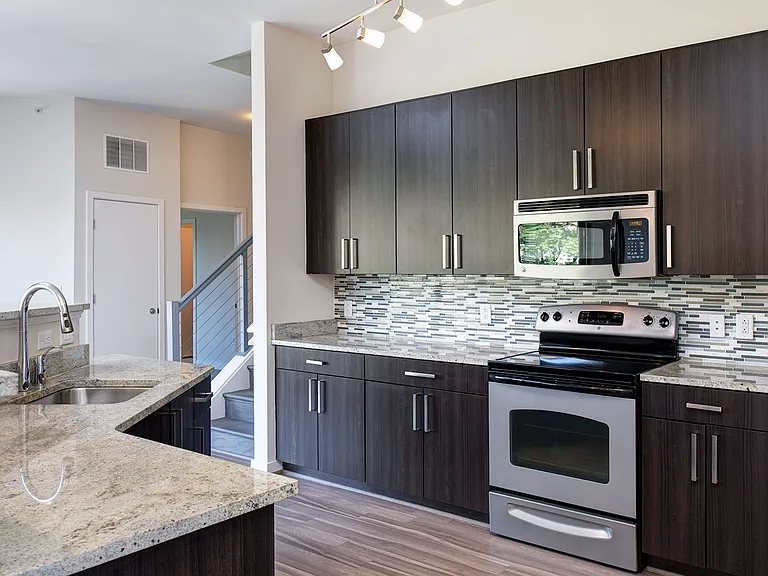 Modern kitchens with granite countertops, stainless steel appliances, and tile backsplash