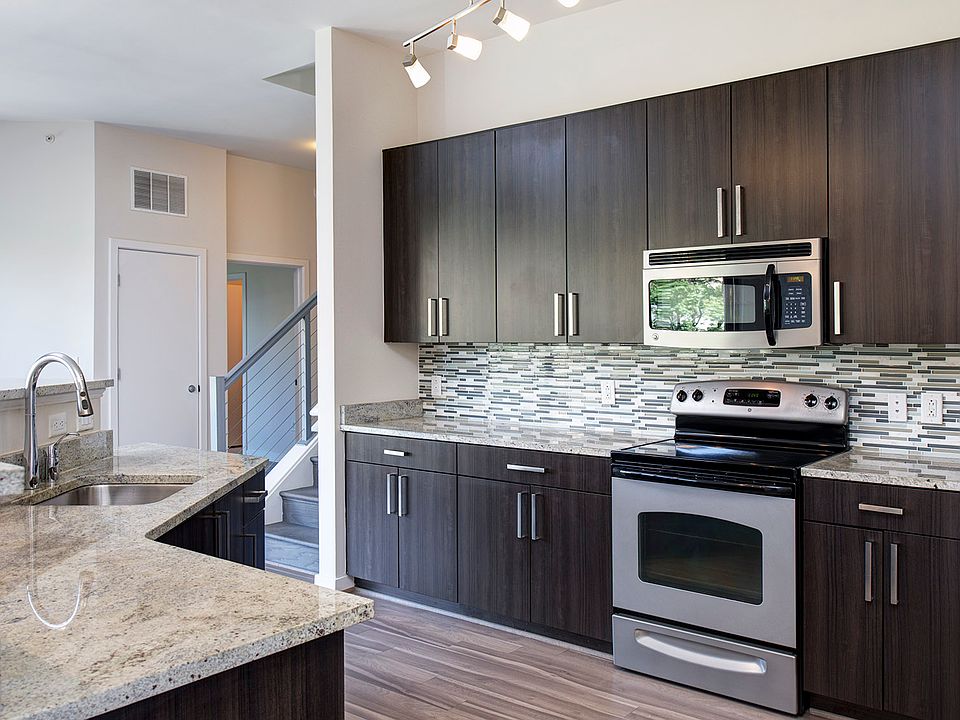 Modern kitchens with granite countertops, stainless steel appliances, and tile backsplash