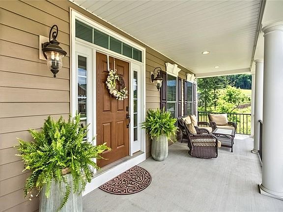 Enjoy your morning coffee on this full length front porch...one of 3 outdoor living spaces!