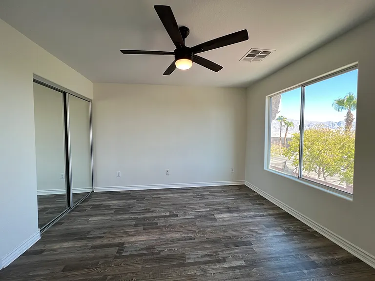 Alternate view of primary bathroom showing mirrored closet doors.