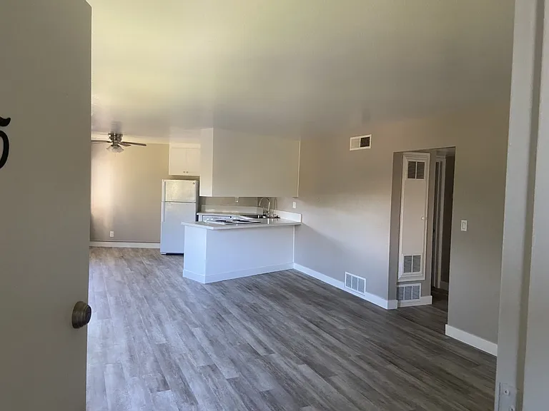 Take in the open-concept layout featuring a full-size, all-electric kitchen with abundant cabinetry and a stylish ceiling fan. Enjoy central heat and air, two-tone paint, and soaring high ceilings throughout.