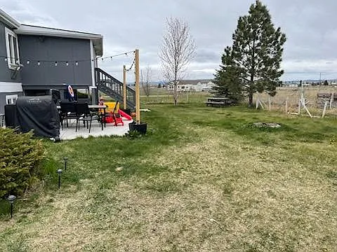 spacious fenced yard with entertainment area