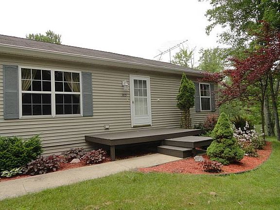 The interesting front porch is surrounded with very attractive lush landscaping!