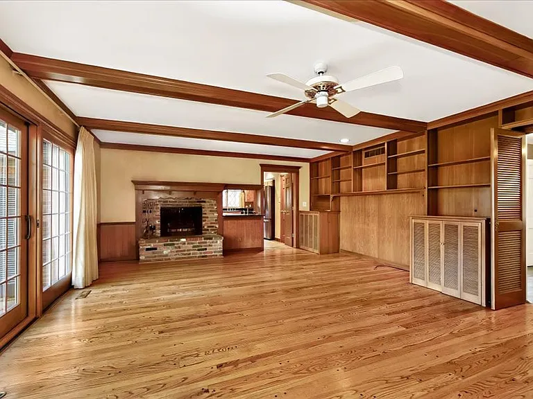 Family room with fireplace and built-in bookselves.