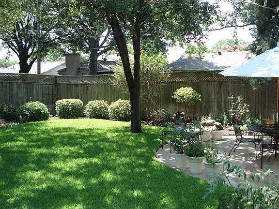 Lush backyard with wonderful patio for relaxing and entertaining