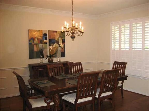 Dining room complete with plantation shutters and hardwood floors!
