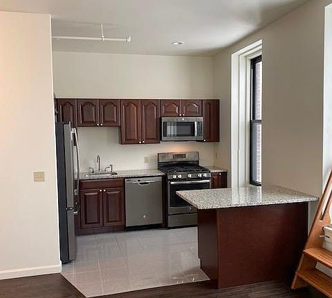 Kitchen with SS appliances, Granite counter tops, and Porcelain tile floor.