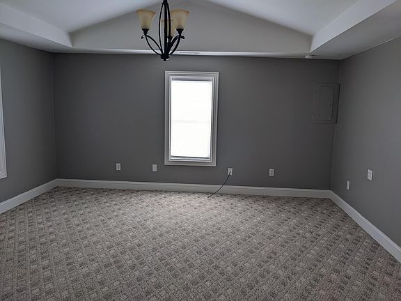 Living room with vaulted ceiling.