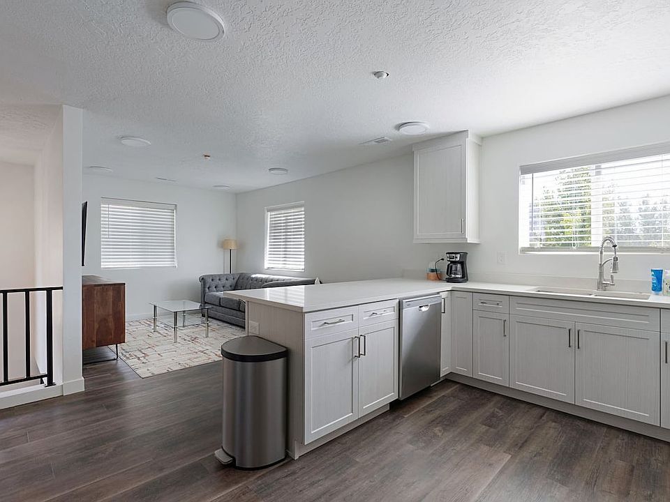 View entering the upstairs: This 2nd floor 3-bedroom, 2-bath apartment (furnished, 12-month lease negotiable) comes fully furnished (TVs and all!) & is ready for long term living.