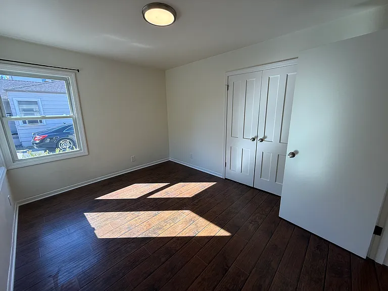 Bedroom #1 with multiple corner windows and spacious double door closet.