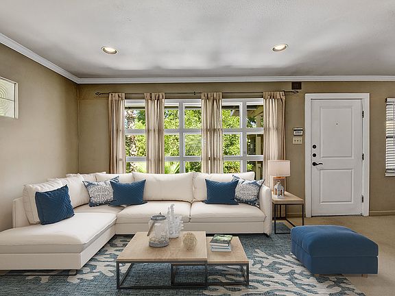 Large open living space with custom windows and central AC for elevated comfort