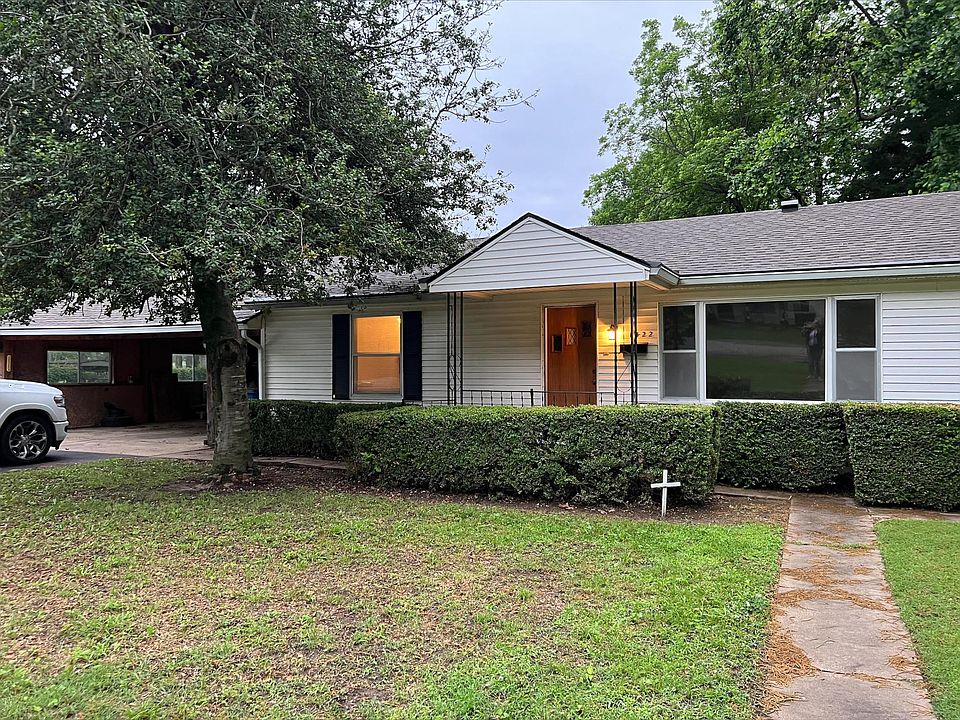 Front of the house with 2 car open garage.