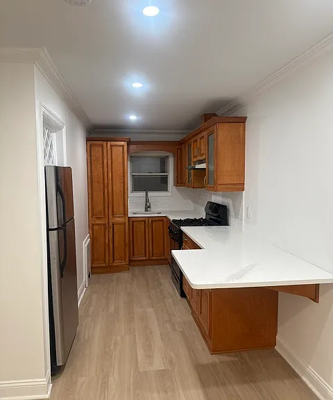 Kitchen featuring wood cabinets, wine rack, quartz countertops & breakfast bar