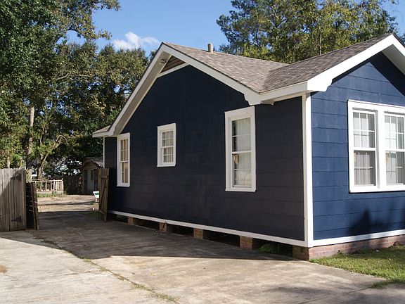 View of the backyard taken from the driveway _ includes rear lot space.