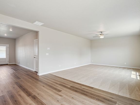 The family room is spacious with a ceiling fan.