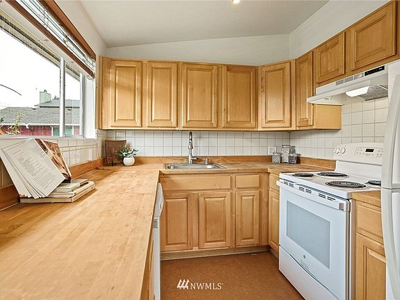 Main floor kitchen with eastern exposure . (Not pictured - washer & dryer in utility closet behind refrigerator.) 7714 18th Ave SW, Seattle, WA 98106 - NWMLS# 1870781