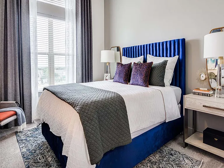 Griffis Frisco apartment bedroom with plush carpet.