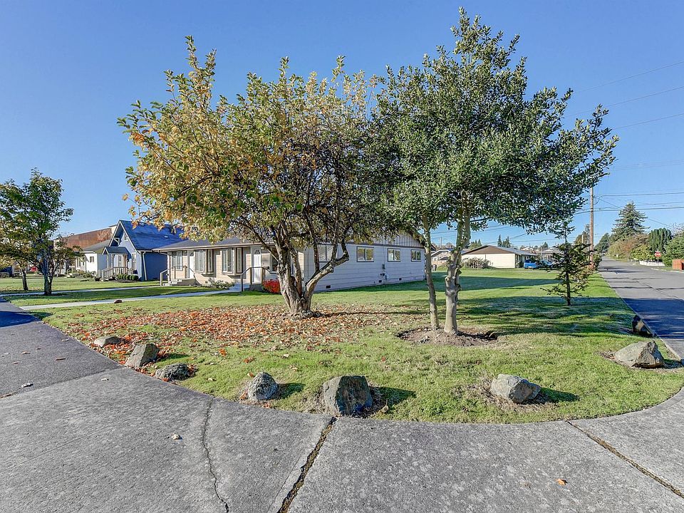 View from the street - leveled corner lot with professionally maintained landscaping.