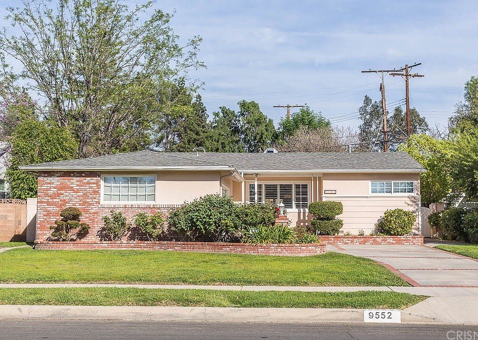 Handsome curb appeal with brick hardscaping, dual
