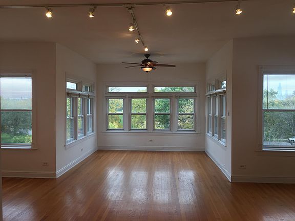 Large living room overlooking the tree filled park