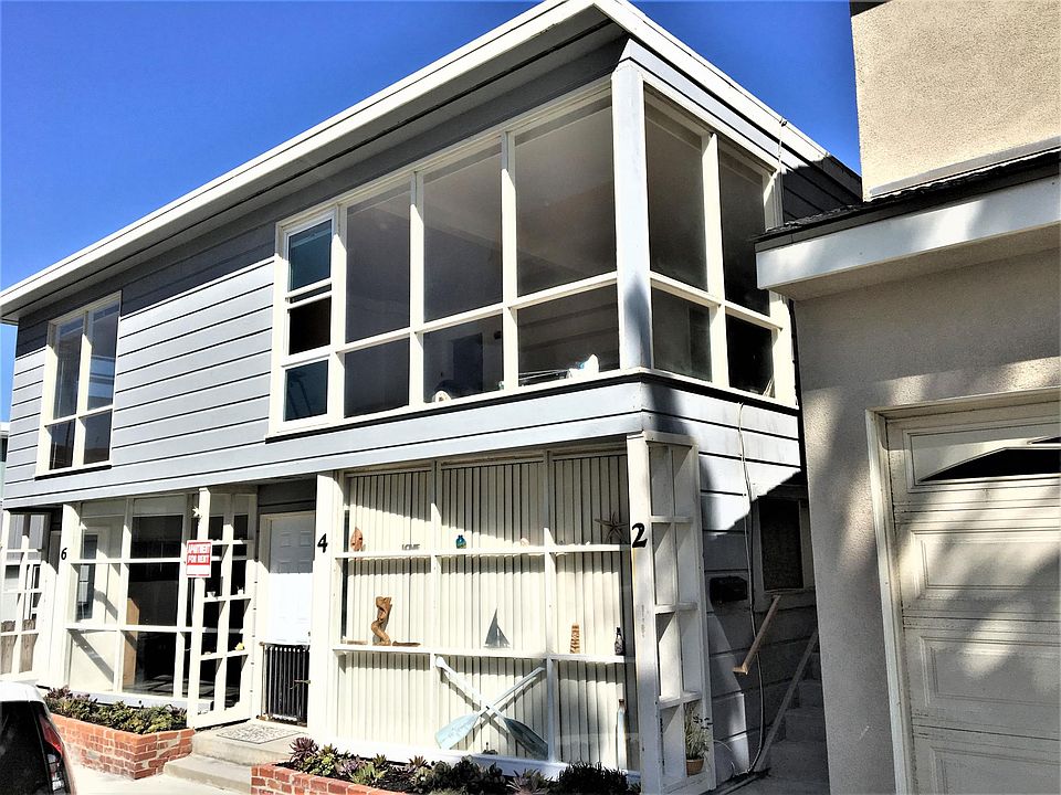 View of outside of triplex. Unit for rent is the lower one in the picture.