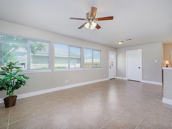 Huge den on the back of home with many windows & utility room by back door.