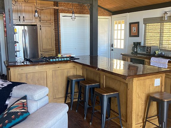 Kitchen/counter top dining. Custom wood counter with live edge. Custom cabinets.