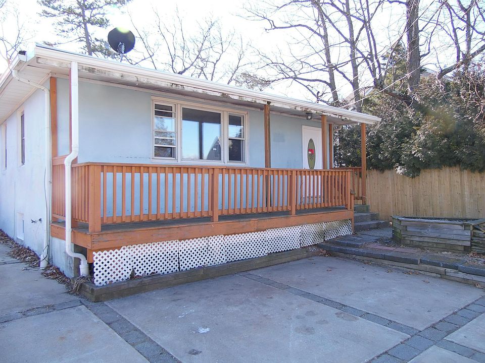 Front with porch, 2 car driveway, and on street parking.