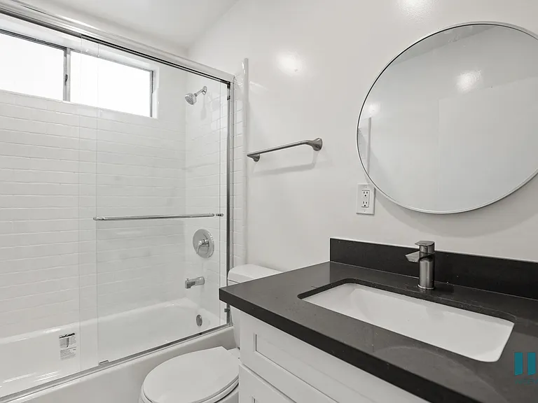 Bathroom with Shower Bath with Glass Door and Vanity Cabinet Storage