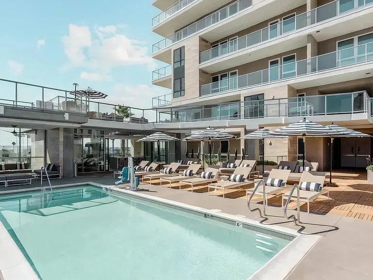 Private Pool Oasis with Lounge Chairs, Umbrellas, and Seating Areas