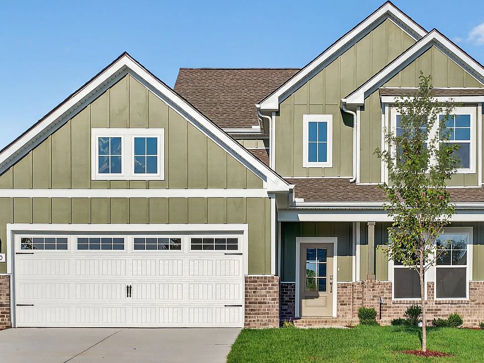 Exquisite McClure Farms residence featuring stylish green facade, classic brickwork, pristine garage
