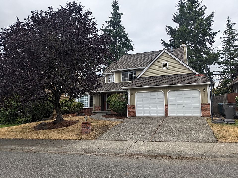Front of the house featuring two car garage and a long driveway