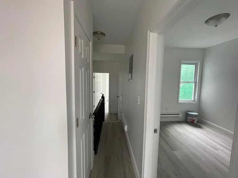 hallway connecting to the 2 bedrooms and the bathroom