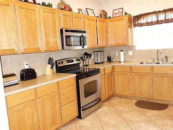 Kitchen showing stainless appliances and tile flooring.