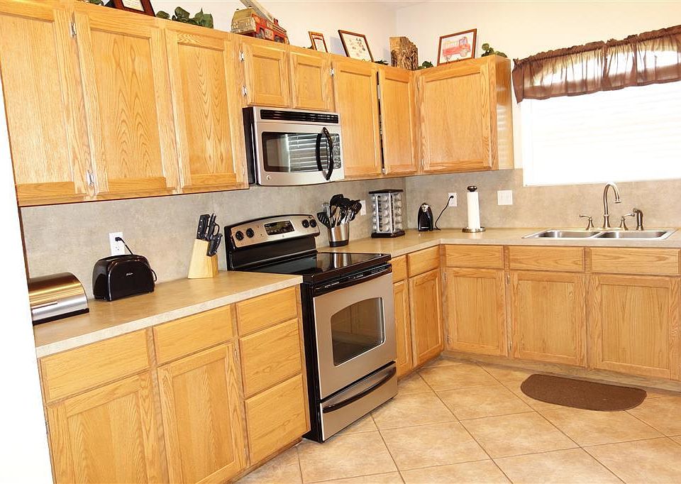 Kitchen showing stainless appliances and tile flooring.