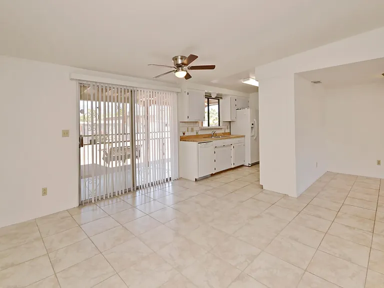 Galley kitchen with eat in dining area and slider to backyard