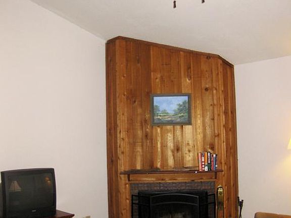View of the large den showing the vaulted ceiling. Pergo flooring continues into this room.