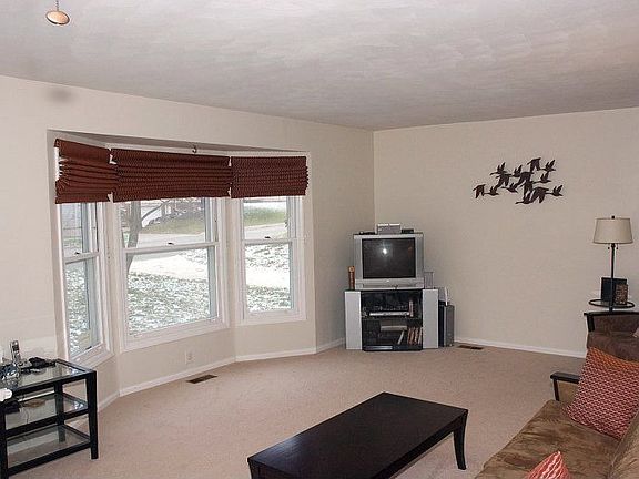 Living room with bay window - custom "Warm Window" shades throughout stay.