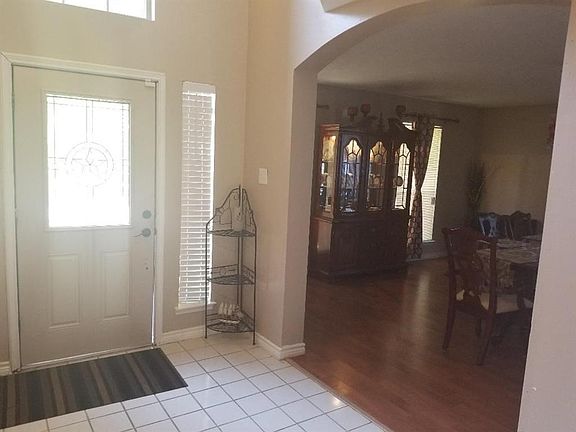 Entry With Lead Glass Front Door*Tile Floors In Entry & Laminate Floors In The Formal Dining Room.