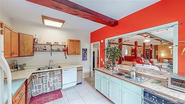 Kitchen - furnished. Looking into large main room before that floor was redone.