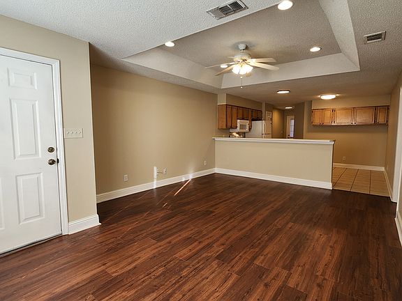 Living room with tray ceiling and recessed lights