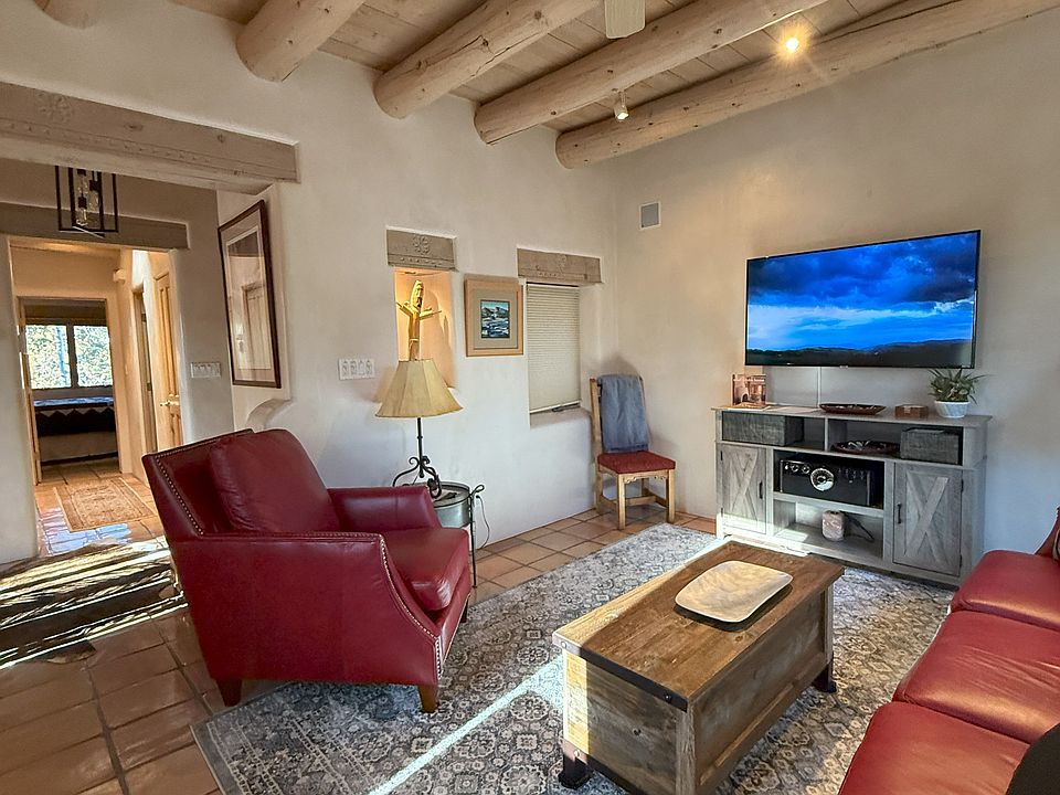 Warm & inviting living room, hand-plastered walls, viga ceilings, 65" flat screen TV, Radiant floor heat, Mini-split with AC, Lots of light