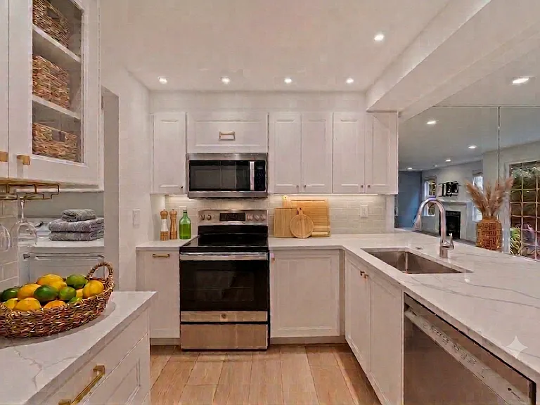 remodeled kitchen with new cabinets, counters, dishwasher and lighting