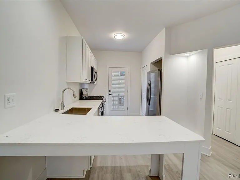 kitchen has stone top and peninsula big enough for 4 barstools