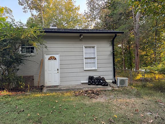 Private entrance next to carport with one covered parking spot.