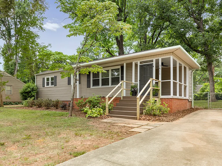 Driveway offers flat off street parking and easy access into the home through beautiful screened porch with new landscaping surrounding.