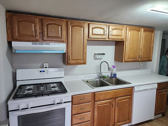 recently renovated kitchen with new stove, double sink with garbage disposal, and dishwasher