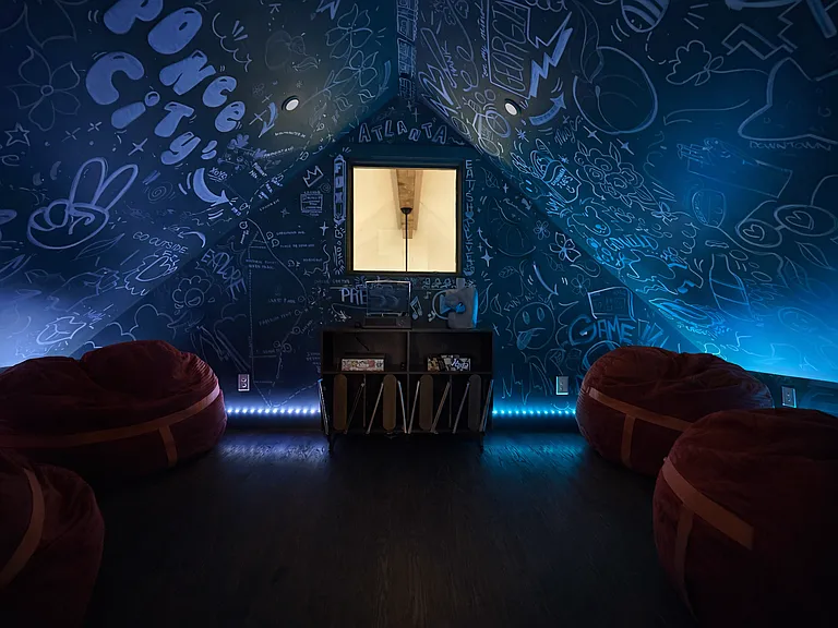 Located on the 2nd floor, the Artwalk Social lounge. Enjoy a curated record player, vinyls, games, large, cozy bean bags, and warm ambient lighting. A private retreat designed for connection, conversation, and unwinding.