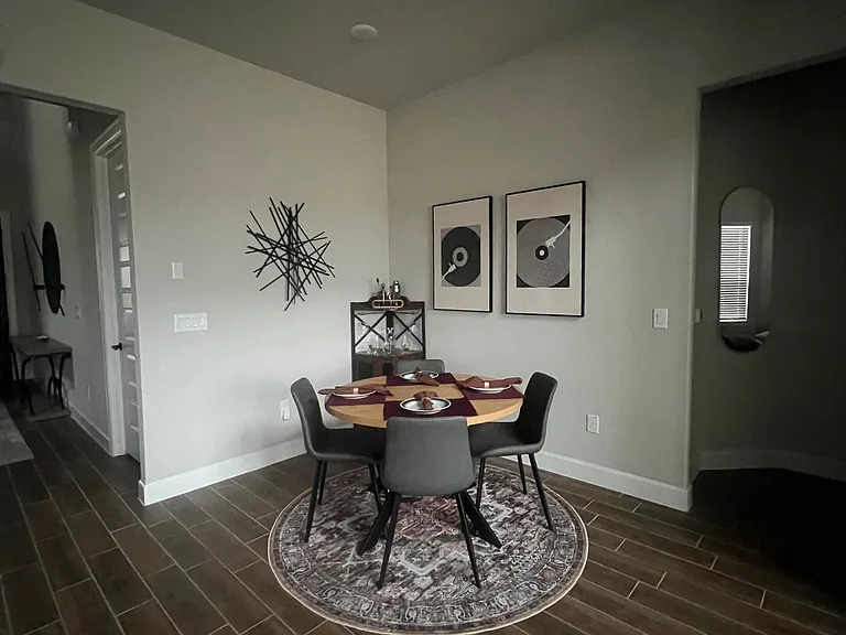 Stylish dining area featuring modern decor, a cozy round table, and elegant finishes_perfect for intimate meals or entertaining guests in a warm, inviting space.