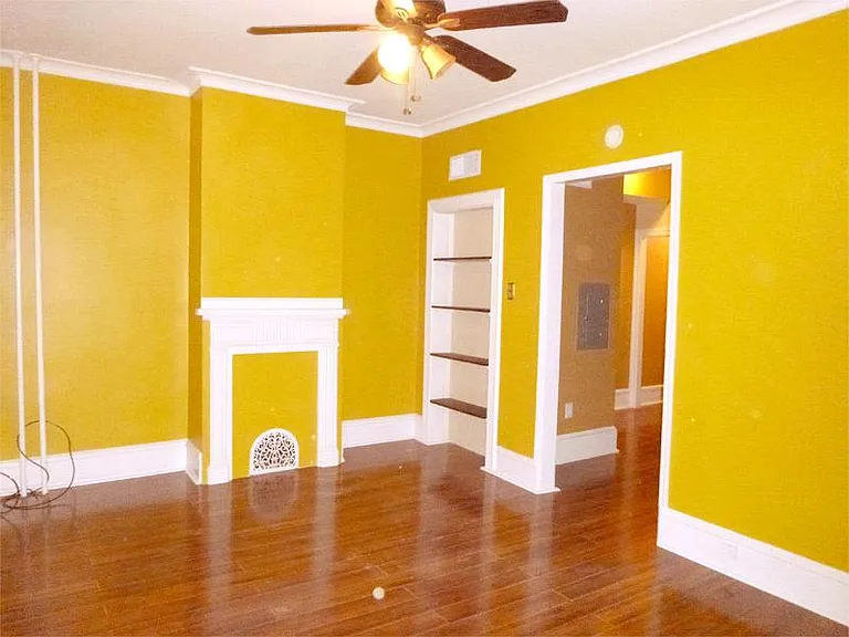 Living room with tigerwood floor, fireplace architectural design, and built-in shelves , painted in a sunny designer color (Paint color is closer to actual color in this picture and not as dark as in other pictures. Looks much nicer in person)